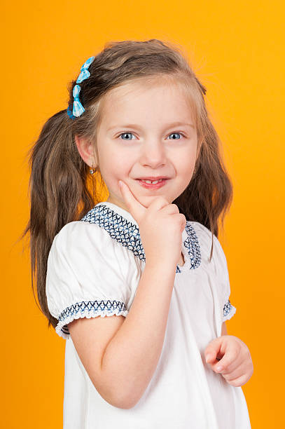 istock smiling girl portrait on yellow 185313363
