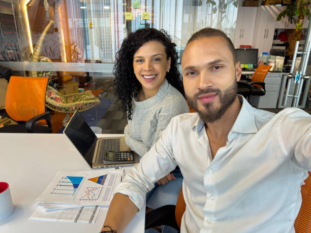 istock Two young colleagues take a selfie working as a team in the office. 1853171826