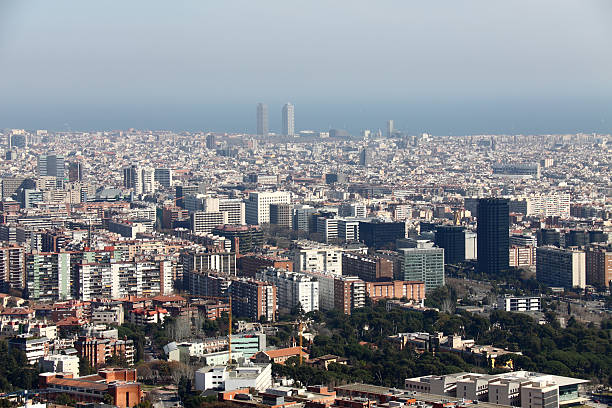 The view of Barcelona from the mountain Serra de Collserola. In the foreground is the pedralbes district and at the backgdound is the sea line.