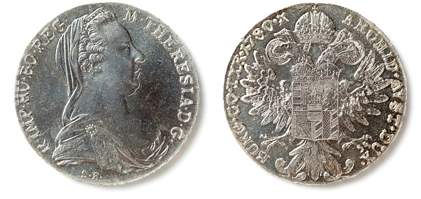 Front and back of a Maria Theresa Thaler (Maria Theresia Taler) coin, isolated on white. The coin is made since 1741 mostly in Austria.