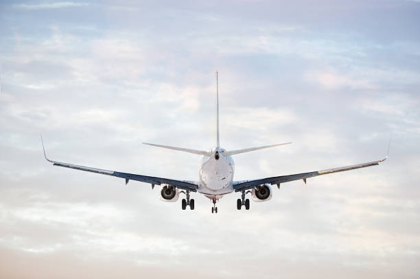 istock Sunlit airplane taking off or lands against bright sky 185318050