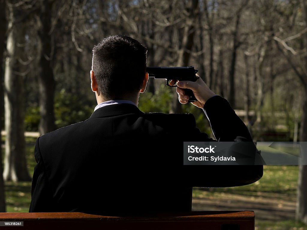 Suicide A business man with a gun to his head. Adult Stock Photo