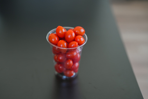 small tomatoes in a clear plastic box