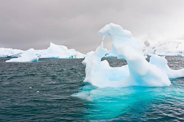 Beautiful Iceberg Iceberg in Antarctic Sea  iceberg dramatic sky wintry landscape mountain stock pictures, royalty-free photos & images