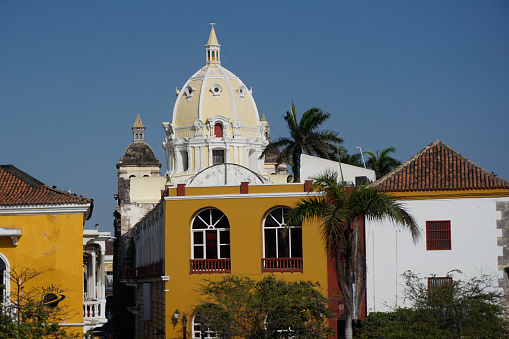 Buildings in Cartagena with the belltower of the Curch of St. Peter Claver, Iglesia de San Pedro Claver in the background, Colombia 2020