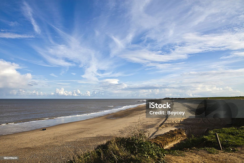 Happisburgh beach This vast expanse of coastline is being eroded away by the strength of the sea. old groynes in the  distance were an attempt to solve the problem but failed Norfolk - England Stock Photo