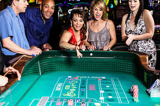 Diverse Group of People Playing Craps In Casino stock photo