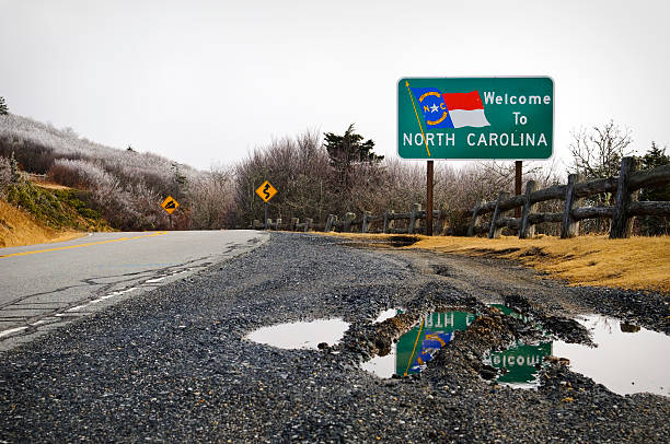 North Carolina state line at Carver's Gap Roan Mountain North Carolina state line and welcome sign at Carver's Gap near Roan Mountain (Tennessee/North Carolina). tennessee road sign stock pictures, royalty-free photos & images