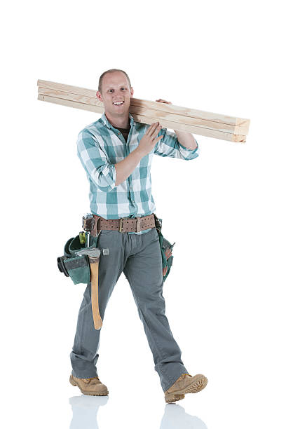istock Carpenter carrying wooden planks 185320022