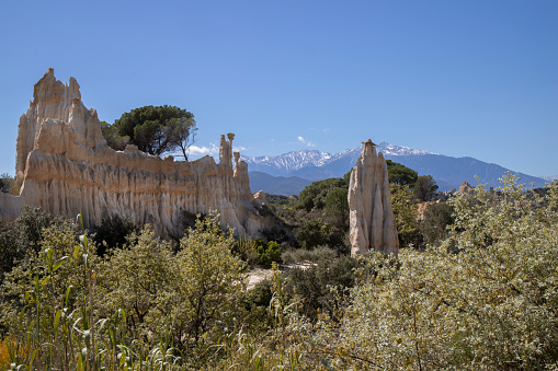 A stunning landscape of the tall rocky formations of Orgues d'Ille in France