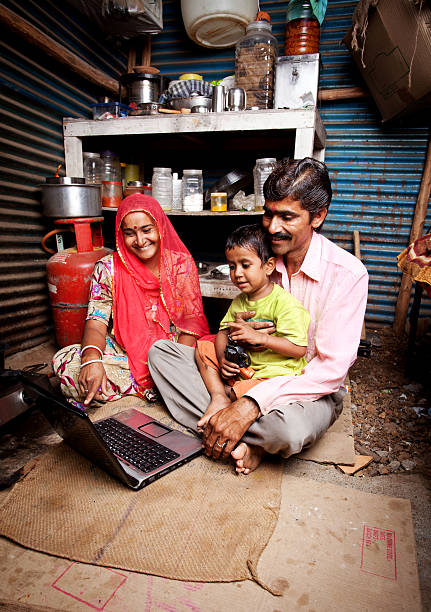 Cheerful Rajasthani Rural Indian Mother Father and Son Using Laptop