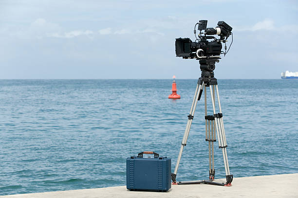 video camera ready to record video camera and accessory bag on the dock positioned to record. cityscape videos stock pictures, royalty-free photos & images