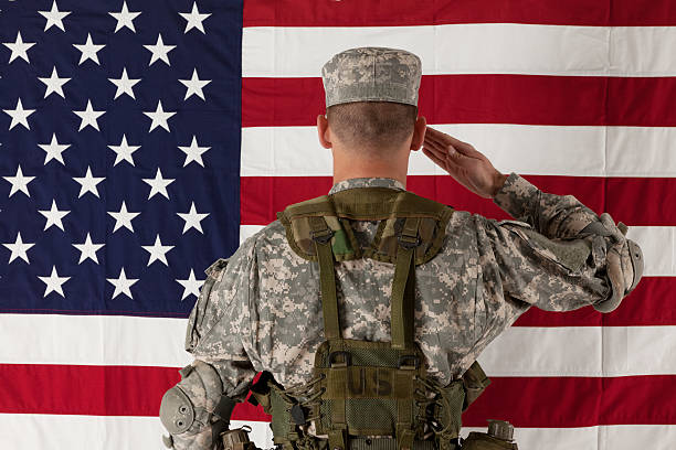 istock Army soldier saluting US flag 185321444