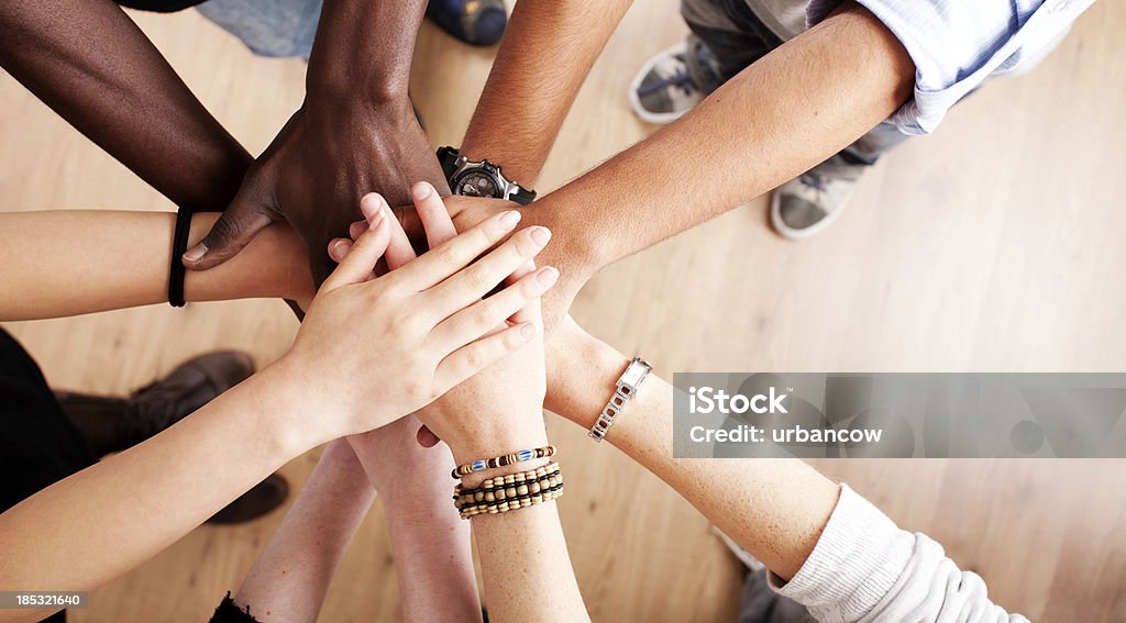 Hands all in Stack of hands Hands Clasped Stock Photo