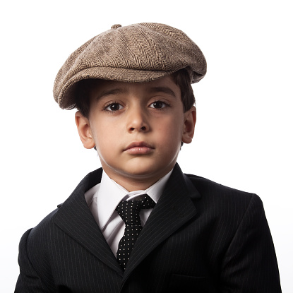 Portrait of little boy wearing striped suit and flat cap
