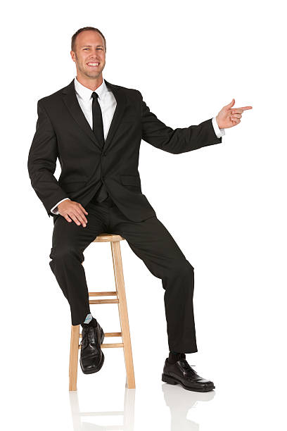 istock Businessman sitting on a stool and pointing 185321746