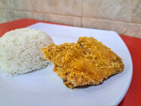 Serving Plate Of Crispy Fried Chicken Breast With Rice. Nasi Ayam Goreng Dada