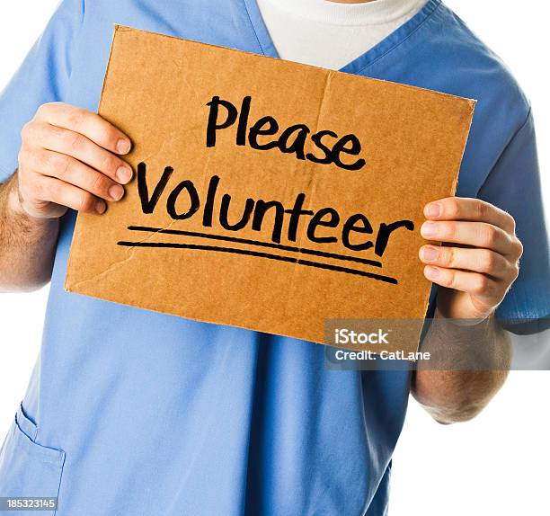 Doctor With Sign Please Volunteer Stock Photo - Download Image Now - 20-29 Years, Adult, Adults Only