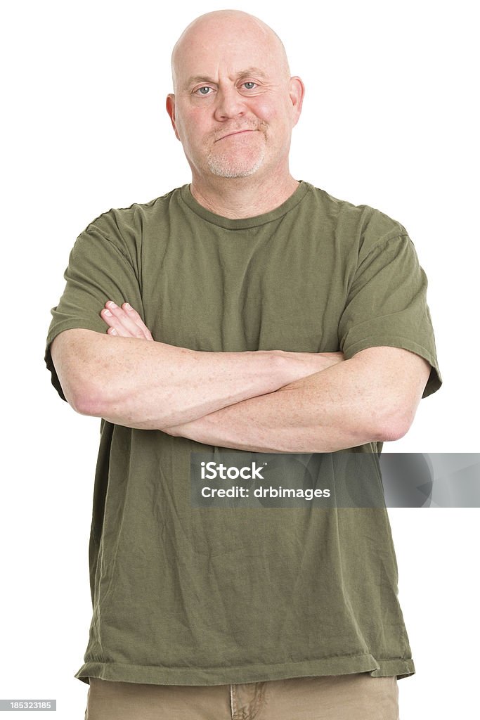 Smirking Man With Arms Crossed Portrait of a mature man on a white background. Men Stock Photo