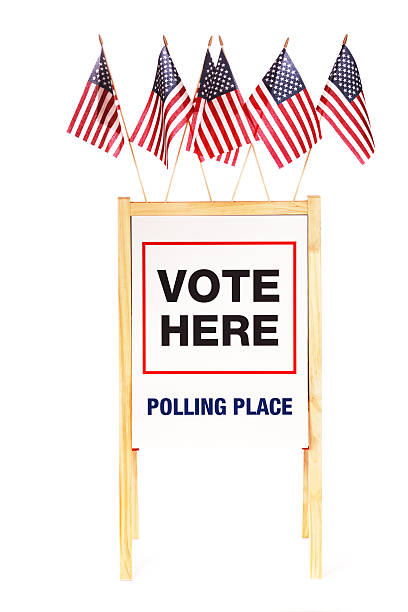 istock USA Vote Here Polling Place Sign with Flags on White 185323433