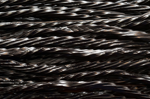 Close up of strips of black liquorice in a row.  See also