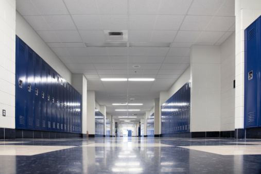 The empty hallway of a high school lined with lockers