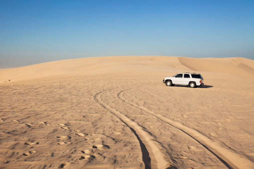 4x4 vehicle parked during a desert safari through the Qatar landscape.
