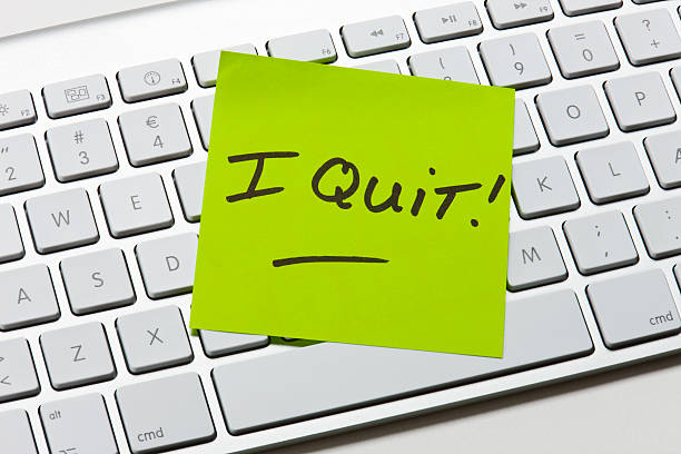 A green sticky note of resignation I Quit Note on keyboard quitting a job stock pictures, royalty-free photos & images