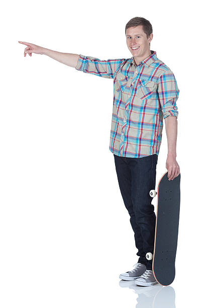 istock Man holding a skateboard and smiling 185325269