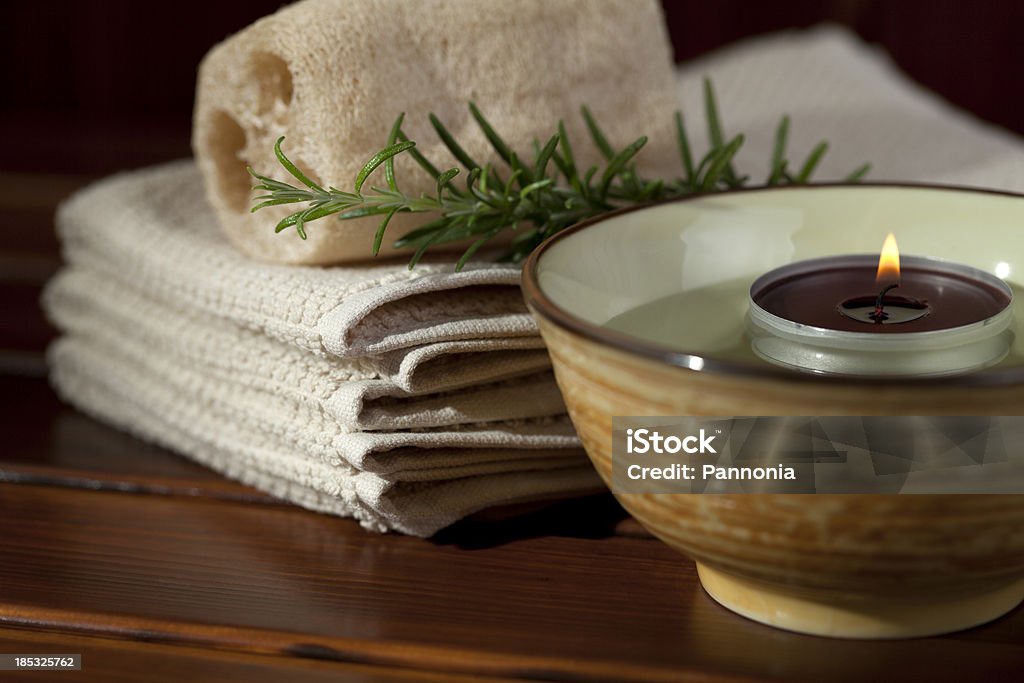 Spa with Candle Light "Stock photo of spa arrangement with candle, bowl, loofah, towel, rosemary" Beauty Stock Photo