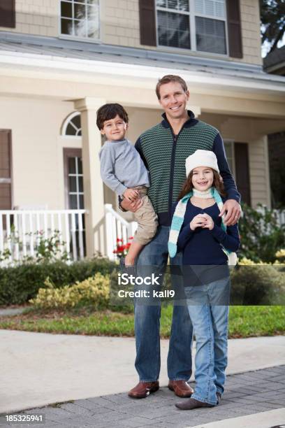 Father With Children Standing In Front Of House Stock Photo - Download Image Now - 2-3 Years, 30-39 Years, 35-39 Years