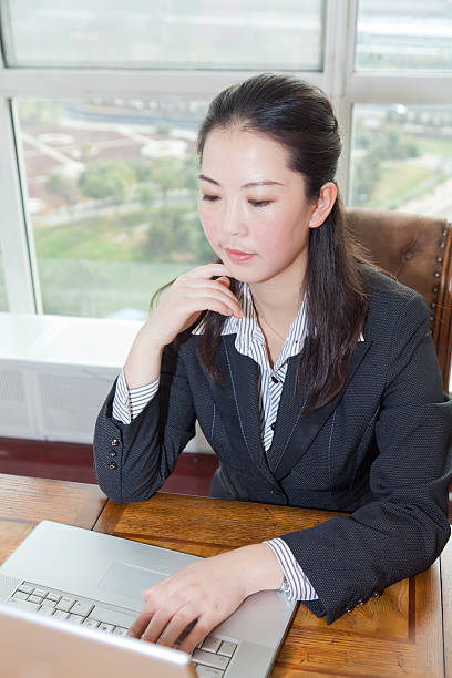 istock Asian businesswoman working with notebook 185326133