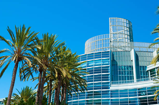 Scenic landscape of Anaheim Convention Center Anaheim Convention Center and Palm Trees.  The Anaheim Convention Center is located right beside the Disneyland Resort in Anaheim, CA and has over 800,000 square feet of floor space. anaheim california stock pictures, royalty-free photos & images