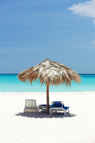 istock Beach scene with lounge chairs and umbrella 185326505