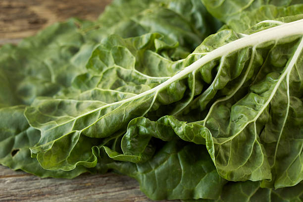 istock Organic collard greens on rustic wood surface 185326812