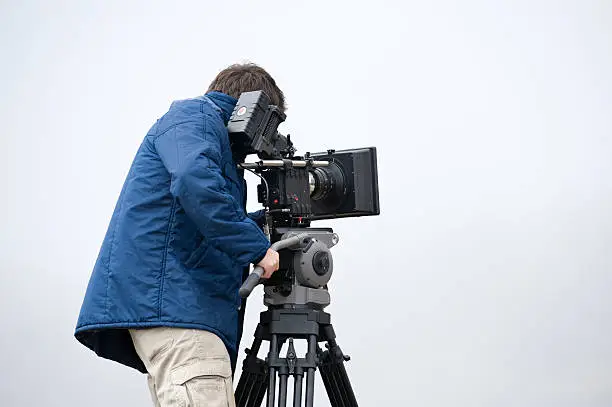 professional video cameraman in full action with cold environment.