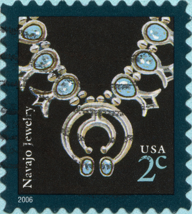 Postmarked stamp with image of Navajo jewelry.  USA 2 cents.
