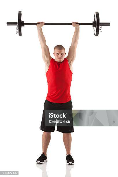 Man Exercising With Barbells Stock Photo - Download Image Now - White Background, Weightlifting, Muscular Build