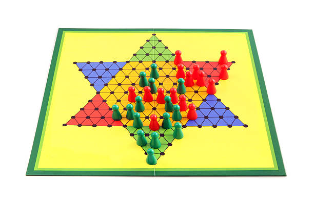 Board game chinese checkers Board game chinese checkers isolated on white background. The game just in the middle of beeing finished. chinese checkers stock pictures, royalty-free photos & images