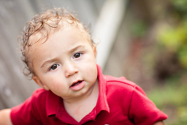 istock Toddler Boy Sitting in Grass Outside on Summer Day 185327457