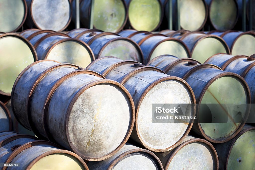 petrol barrels rusty blue petrol barrels in shade Oil Drum Stock Photo