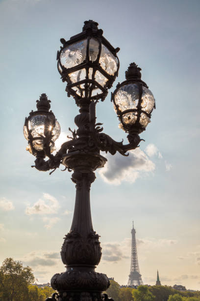 istock Electric lamps on Pont Alexandre Bridge overlooking the Eiffel Tower at sunset 1853278705