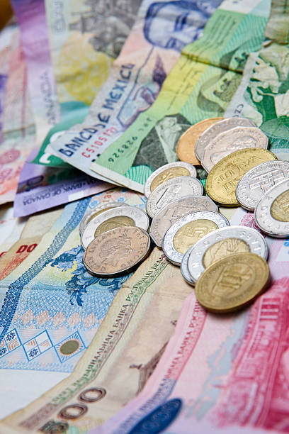 istock Foreign Coins Stacked on Paper Bills 185327929