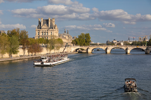 Boat with tourists on the Seine River in Paris, France