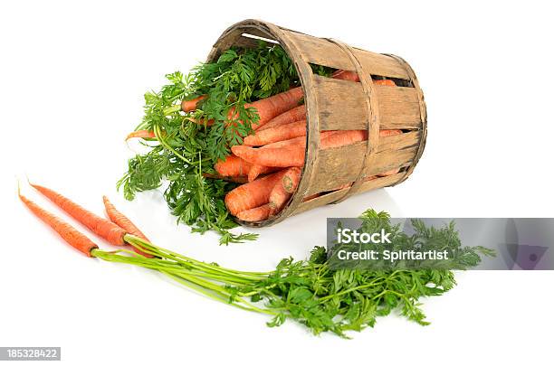 Carrots In A Tipped Rustic Basket Stock Photo - Download Image Now - Apiaceae, Basket, Brown