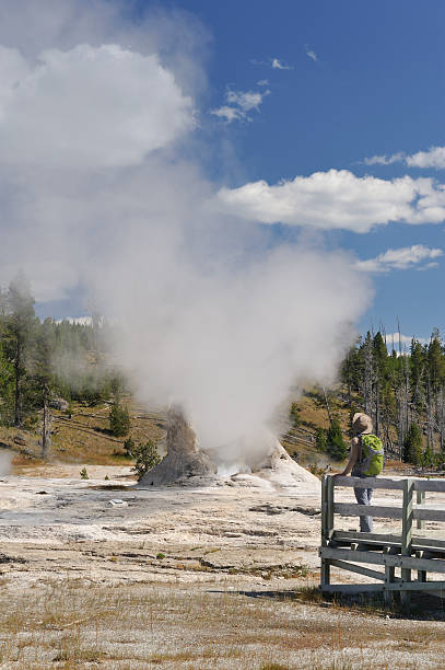 istock Tourist looking at geyser 185328475