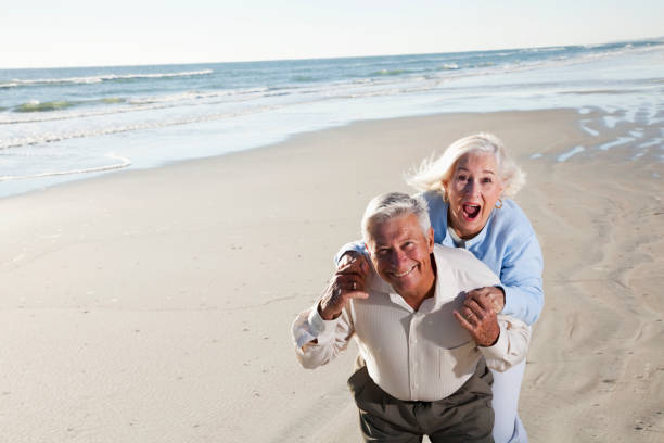 istock Senior couple laughing on beach 185329102