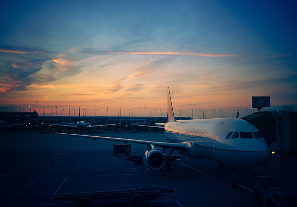 Airport at sunset "airplane at the gate getting ready for departure, chicago international airport" ca04 stock pictures, royalty-free photos & images