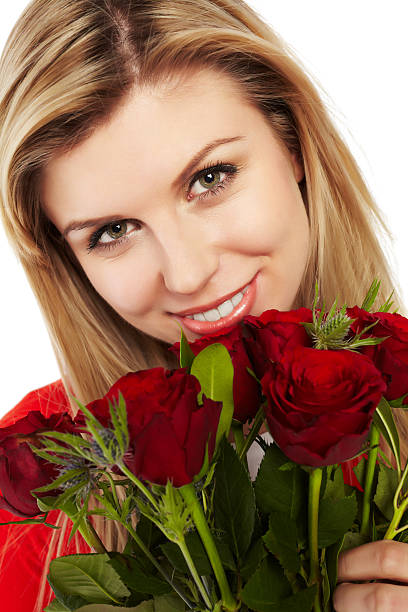 istock Valentine - Charming young lady holding red roses 185329346