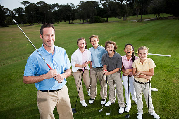 istock Golf pro with group of children on driving range 185329401
